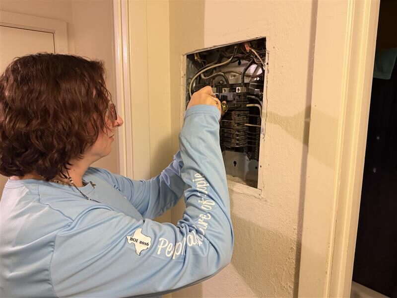 Sand Star team member servicing an electrical panel during facility maintenance